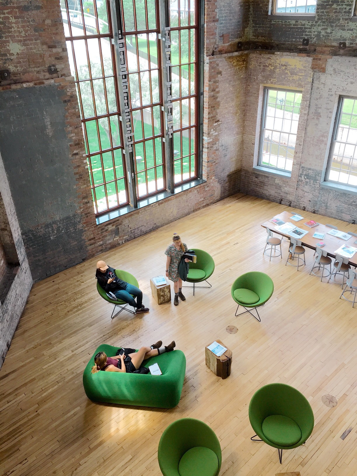 lofty-lobby-millennials-gather-in-a-modern-minimal-mixed-use-space-in-a-repurposed-mill-building_t20_V7mnoP